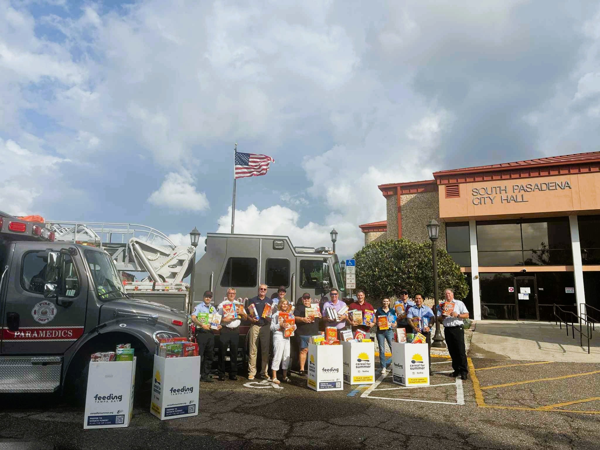 Group photo outside of city hall with the Cereal for Summer Donations 
